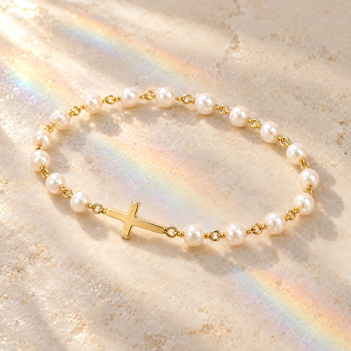 Pearl Cross Bracelet on a sunlit marble surface